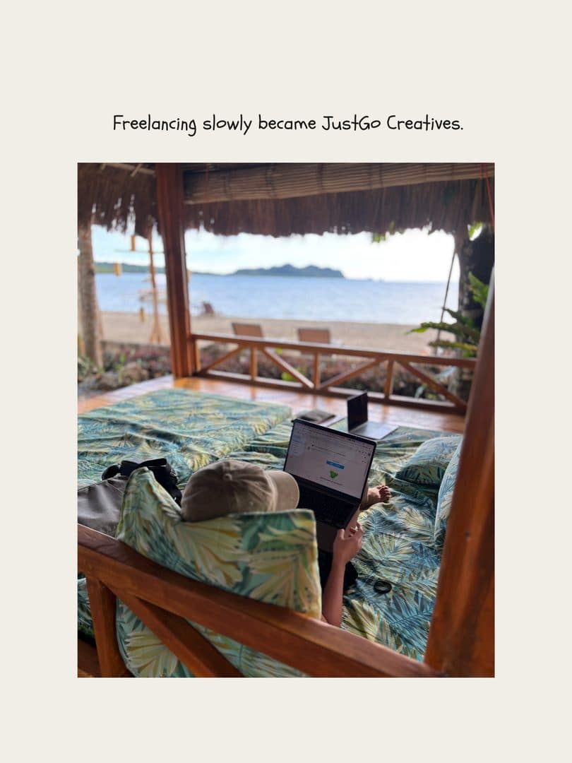 A laptop on a bed in a beachfront hut, the sea just outside