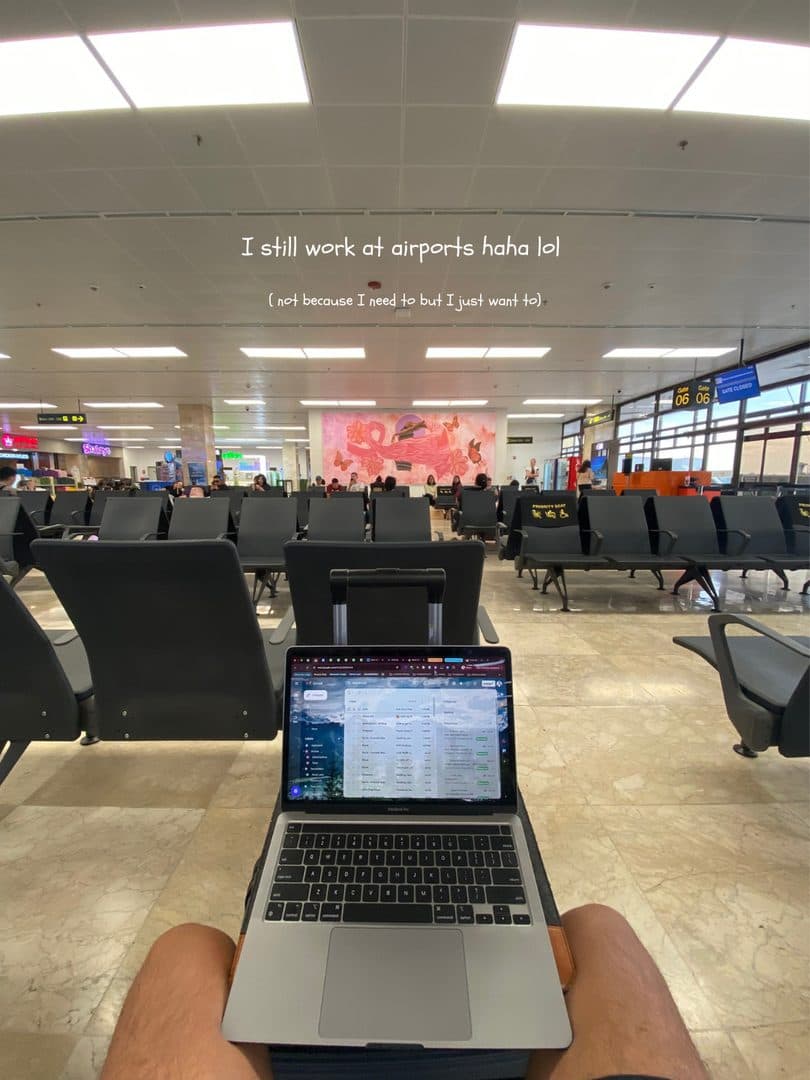 A laptop on Godfrey’s lap at an airport departure gate